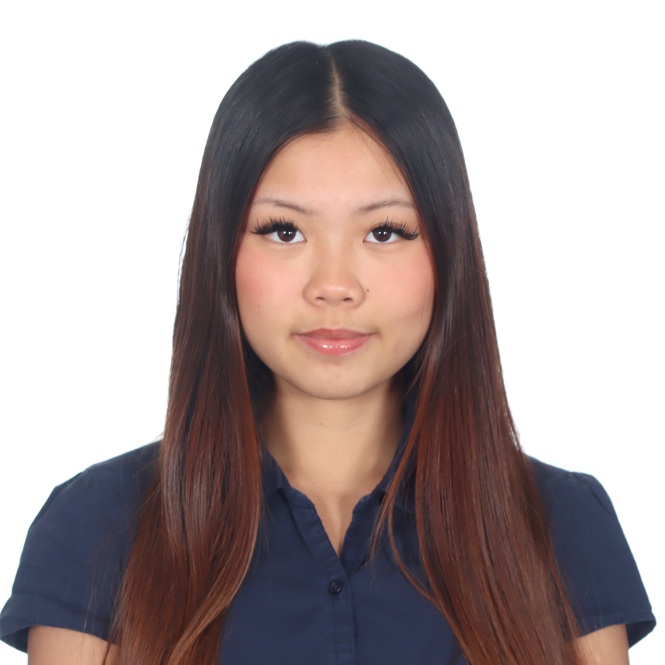 Studio headshot of Phoebe with long straight dark hair, wearing a navy blouse against a white background.